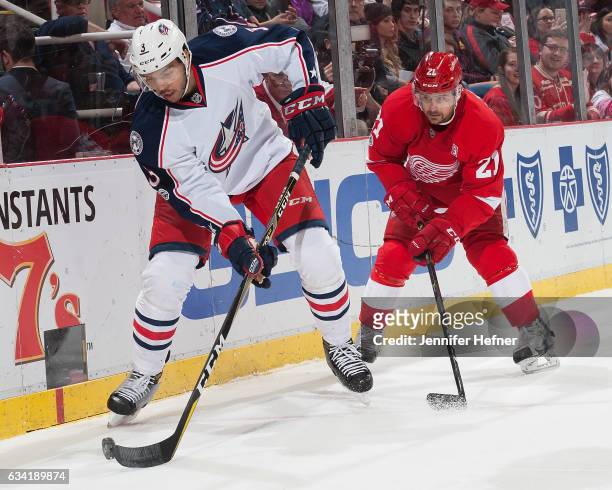 Seth Jones of the Columbus Blue Jackets handles the puck as Tomas Tatar of the Detroit Red Wings pressures him during an NHL game at Joe Louis Arena...