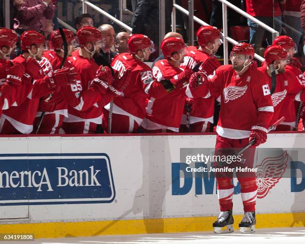 Thomas Vanek of the Detroit Red Wings taps gloves with teammates on the bench after scoring a power play goal during an NHL game against the Columbus...