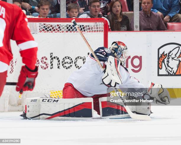 Goalie Sergei Bobrovsky of the Columbus Blue Jackets makes a glove save during an NHL game against the Detroit Red Wings at Joe Louis Arena on...