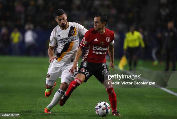 Juan Carlos Nunez of Club Tijuana protects the ball from Sebastian Lletget of the Los ANgeles Galaxy during the first half of their friendly match at...