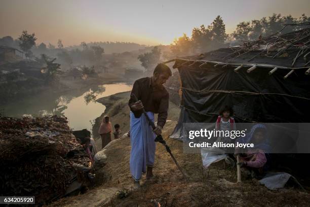 Abdul Shukor works on his home in Kutapalong Rohingya refugee camp on February 8, 2017 in Cox's Bazar, Bangladesh. Shukor fled to Bangladesh 2 months...