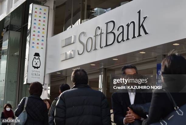 The logo of Japanese mobile provider SoftBank is displayed at an entrance of a shop in Tokyo's shopping district Ginza on February 8, 2017. SoftBank...