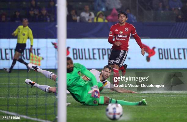 Amando Moreno of Club Tijuana and goalkeeper Clement Diop and Dave Romney of the Los Angeles Galaxy watch Moreno's shot go wide of the post during...