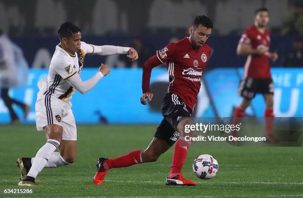 Henry Martin of Club Tijuana plays the ball from Ariel Lassiter of the Los Angeles Galaxy during their friendly match at StubHub Center on February...