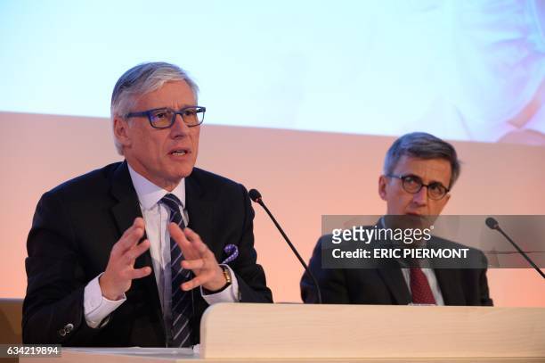 Of French drugmaker Sanofi Olivier Brandicourt , flanked by CFO Jerome Contamine, speaks during the presentation of the group's 2016 results in Paris...
