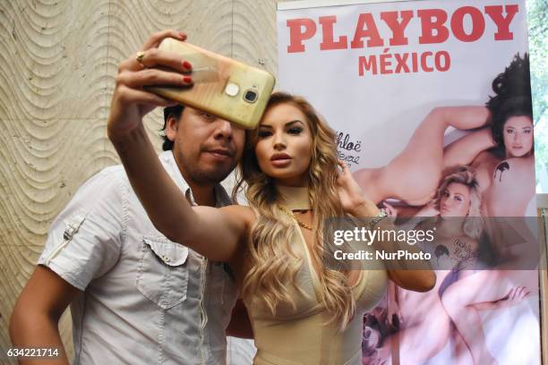 Playmate Amy Lee Summers is seen take a selfie with a fan during the launch of 'Chocolate Fantasies' Playboy Mexico Magazine at Rustic Kitchen on...