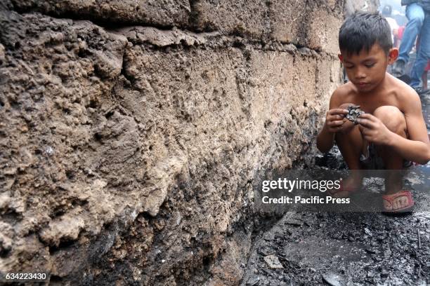 The young boy fire victims collecting some metal wire that he sold to the junk shop to get money. More than 1,100 houses and more than 3,500 families...