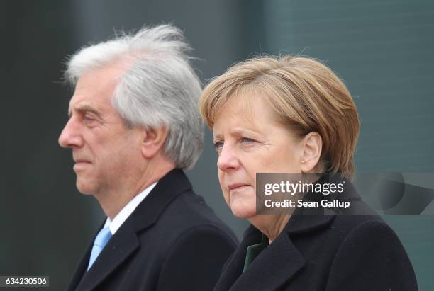 German Chancellor Angela Merkel and Uruguayan President Tabare Vazquez listen to their countries' national anthems upon Vazquez's arrival at the...