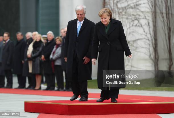 German Chancellor Angela Merkel and Uruguayan President Tabare Vazquez descend from a podium after listening to their countries' national anthems...