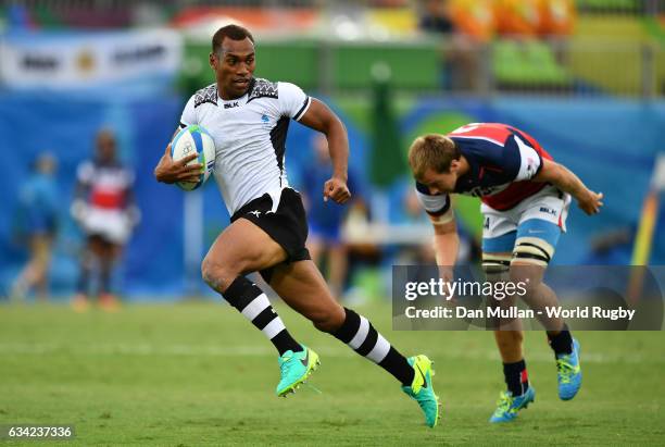 Osea Kolinisau of Fiji makes a break past Ben Pinkleman of the United States to score a try during the Men's Rugby Sevens Pool A match between Fiji...