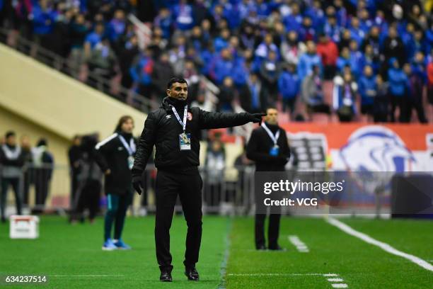 John Aloisi, head coach of Brisbane Roar, speaks to his players during the AFC Champions League 2017 play-off match between Shanghai Shenhua and...