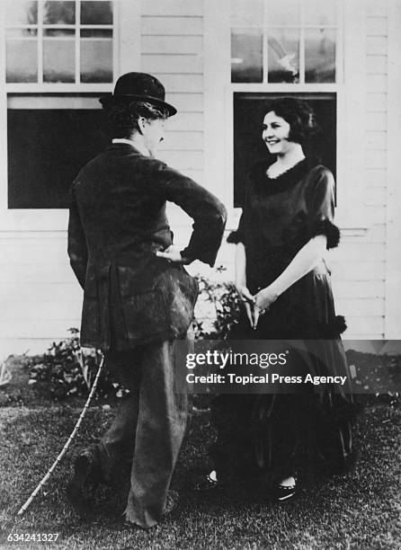 English comic actor and filmmaker Charlie Chaplin with his second wife, actress Lita Grey on the set of his film 'The Gold Rush', USA, November 1924....