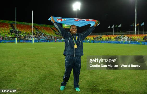 Osea Kolinisau of Fiji poses with the Fiji flag following victory during the Men's Rugby Sevens Gold Medal match between Fiji and Great Britain on...