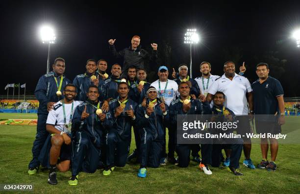 The Fiji players and staff pose following their victory during the Men's Rugby Sevens Gold Medal match between Fiji and Great Britain on day six of...