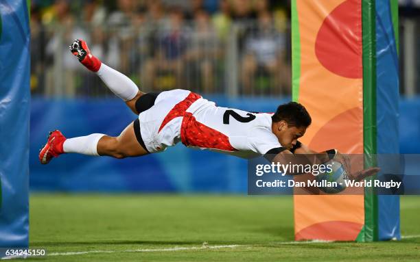 Kazuhiro Goya of Japan dives over for a try during the Men's Rugby Sevens Bronze Medal match between Japan and South Africa on day six of the Rio...