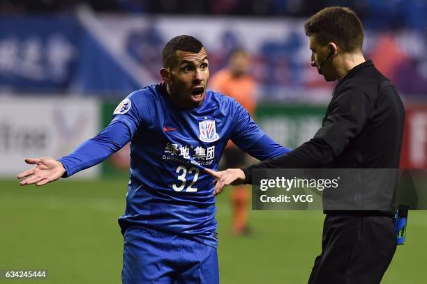 Carlos Tevez of Shanghai Shenhua argues with the referee Valentin Kovalenko during the AFC Champions League 2017 play-off match between Shanghai...