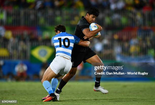 Reiko Ioane of New Zeland is tackled by Bautista Ezcurra of Argentina during the Men's Rugby Sevens placing match between New Zealand and Argentina...