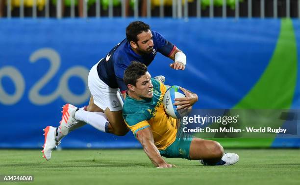Ed Jenkins of Australia dives over for a try under pressure from Julien Candelon of France during the Men's Rugby Sevens placing match between France...