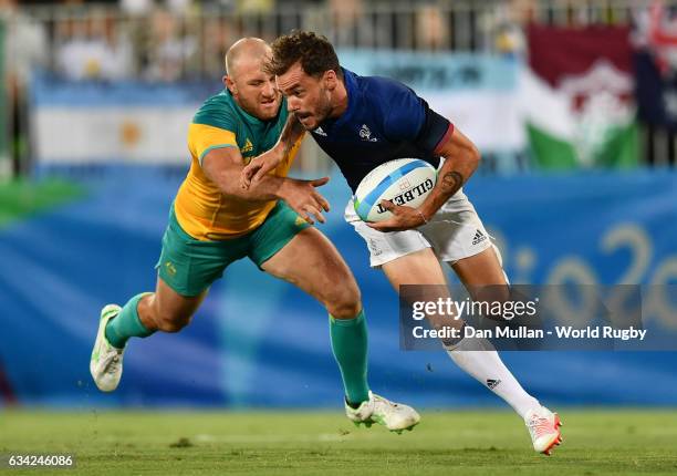 Terry Bouhraoua of France holds off James Stannard of Australia during the Men's Rugby Sevens placing match between France and Australia on day six...