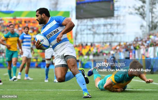 Gaston Revol of Argentina beats Pat McCutcheon of Australia to scores a try during the Men's Rugby Sevens placing match between Argentina and...