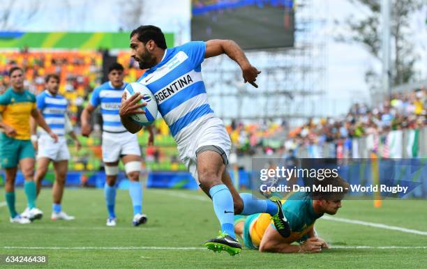 Gaston Revol of Argentina beats Pat McCutcheon of Australia to scores a try during the Men's Rugby Sevens placing match between Argentina and...