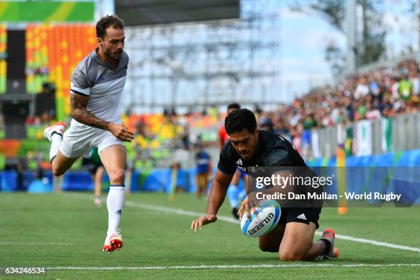 Akira Ioane of New Zeland holds off Terry Bouhraoua of France to score a try during the Men's Rugby Sevens placing match between New Zealand and...