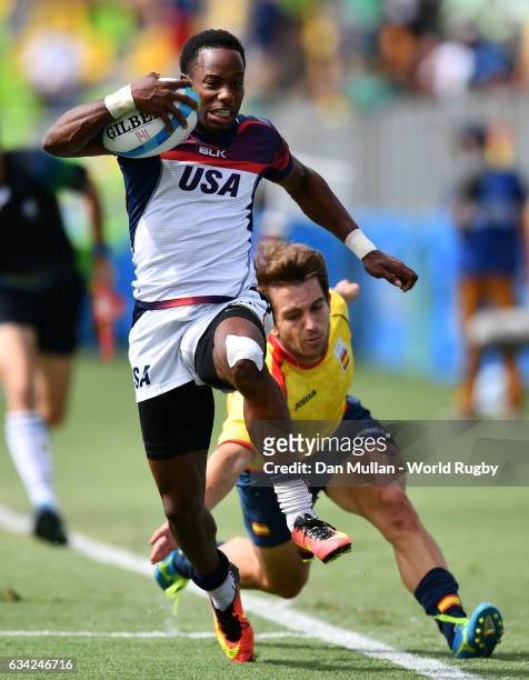 Carlin Isles of the United States makes a break past Marcos Poggi of Spain to score a try during the Men's Rugby Sevens placing match between the...
