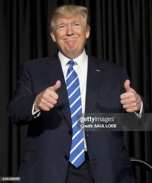 President Donald Trump gives a double thumbs-up as he arrives to speak at the Major Cities Chiefs Association and Major County Sheriff's Association...