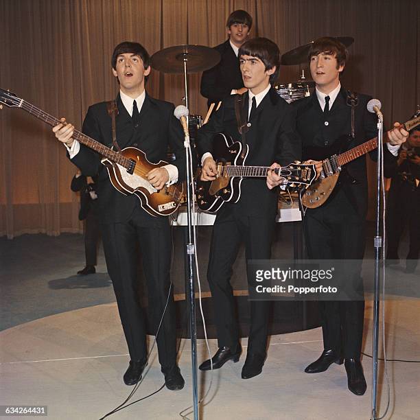 English pop group The Beatles, from left to right, Paul McCartney, Ringo Starr, George Harrison and John Lennon pose with their instruments as they...