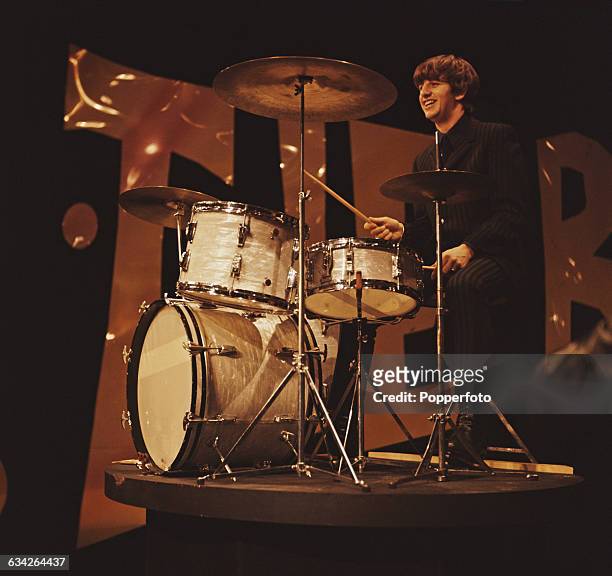 English musician and drummer with The Beatles, Ringo Starr pictured at his drum kit during rehearsals the day before the band's first appearance on...