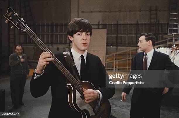 Paul McCartney of English pop group The Beatles pictured with his Hofner 500/1 'violin' bass guitar during rehearsals the day before the band's first...