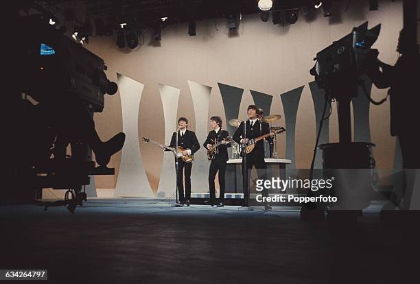 English pop group The Beatles perform before television cameras on The Ed Sullivan Show at CBS's Studio 50 in New York City on 9th February 1964. The...