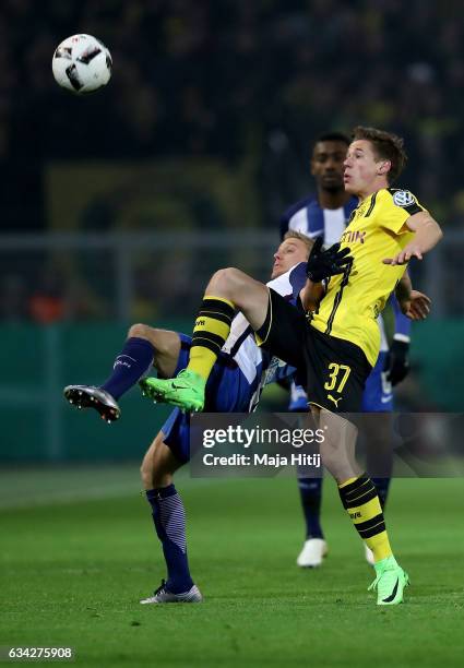 Erik Durm of Dortmund and Per Skjelbred of Berlin battle for the ball during the DFB Cup Round of 16 match between Borussia Dortmund and Hertha BSC...