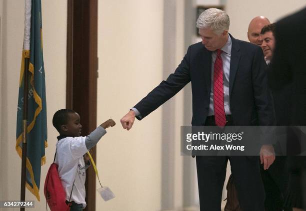 Supreme Court nominee Judge Neil Gorsuch fist-bumps four-year-old Charles Marshall, III , of Dover, Delaware, in the hallway as he arrives for a...