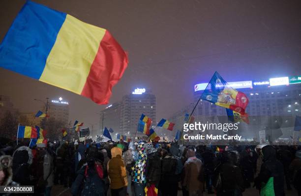 People demonstrate and protest in front of the government headquarters in Victory Square in central Bucharest on February 8, 2017 in Bucharest,...