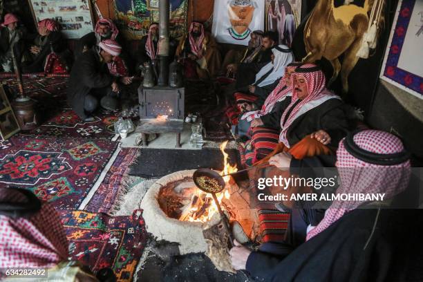 Syrian Bedouins roast coffee beans in a camp during a gathering of tribesmen near the town of Hamouria, in the eastern Ghouta region on the outskirts...