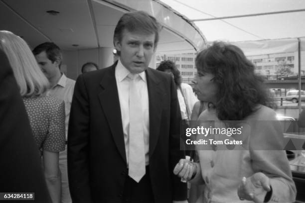 Janet Villella talks with business man Donald Trump as he and his wife Ivana Trump introduce the press to preview the recently refurbished 300 foot...