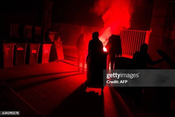 Protesters burn garbage containers during a protest in support of a man allegedly abused while in police custody in Aulnay-sous-Bois, on February 8,...