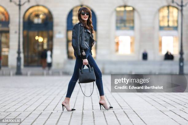 Sarah Benziane, fashion blogger from Les Colonnes de Sarah, wears Newlook white shoes with black heels, Newlook blue denim jeans, a Newlook black...