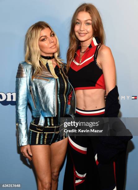 Recording artist Fergie and model Gigi Hadid pose at the TommyLand Tommy Hilfiger Spring 2017 Fashion Show on February 8, 2017 in Venice, California.