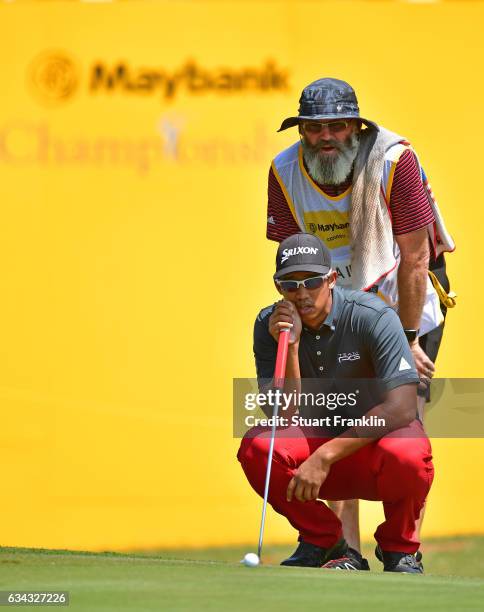 Arie Irawan of Malaysia lines up a putt during Day One of the Maybank Championship Malaysia at Saujana Golf Club on February 9, 2017 in Kuala Lumpur,...