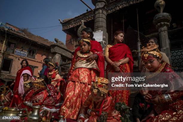 Young Nepalese girls dressed up as brides, accompanied by their mothers, take part in the Bel Bibaha ritual, celebrated by the Newari ethnicity,...