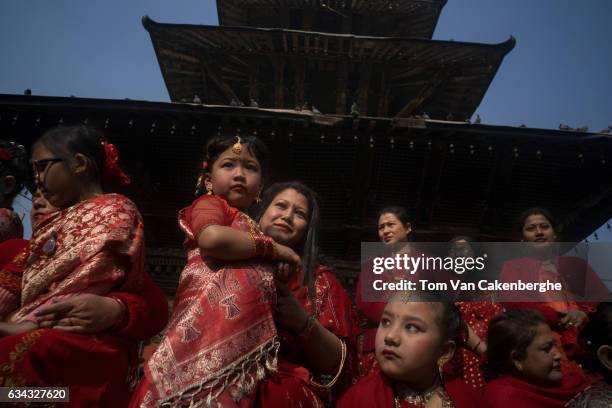 Young Nepalese girls dressed up as brides are accompanied by their mothers to take part in the Bel Bibaha ritual, celebrated by the Newari ethnicity,...