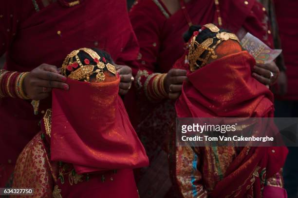 Young Nepalese girls dressed up as brides receive vermilion tika on the forehead during the Bel Bibaha ritual, celebrated by the Newari ethnicity,...