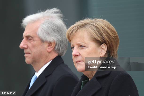 German Chancellor Angela Merkel and Uruguayan President Tabare Vazquez listen to their countries' national anthems upon Vazquez's arrival at the...
