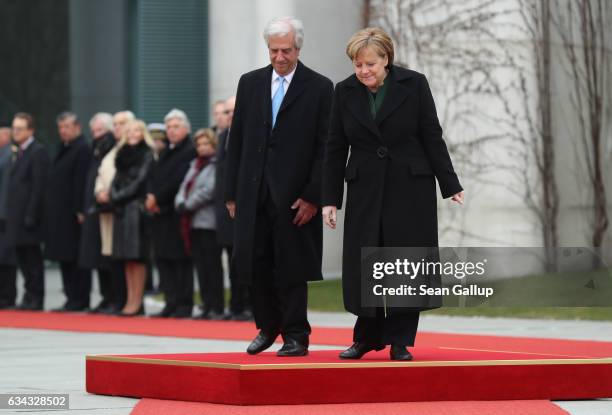 German Chancellor Angela Merkel and Uruguayan President Tabare Vazquez descend from a podium after listening to their countries' national anthems...