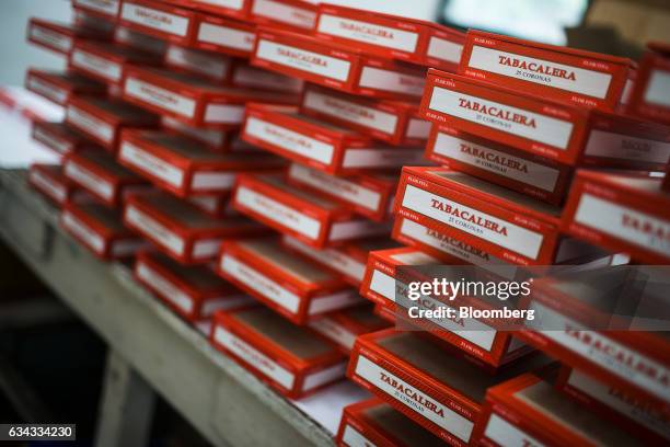 Cigars packed in boxes sit in stacks at the Tabacalera Incorporada cigar factory in the Carmona area of Cavite, the Philippines, on Friday, Feb. 3,...