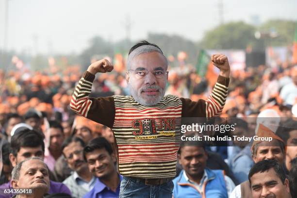 Indian supporters of the Bharatiya Janata Party listen as Prime Minister Narendra Modi speaks during a election rally in Ghaziabad.