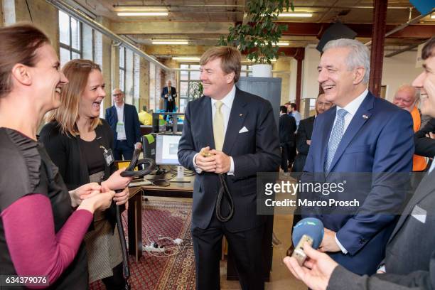 King Willem-Alexander Of The Netherlands and Saxony Prime Minister Stanislaw Tillich talk to young entrepreneurs during a visit to the Spinlab - a...