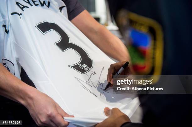 Jordan Ayew signs a shirt after signing a contract with Swansea City at The Fairwood Training Ground on February 08, 2017 in Swansea, Wales.